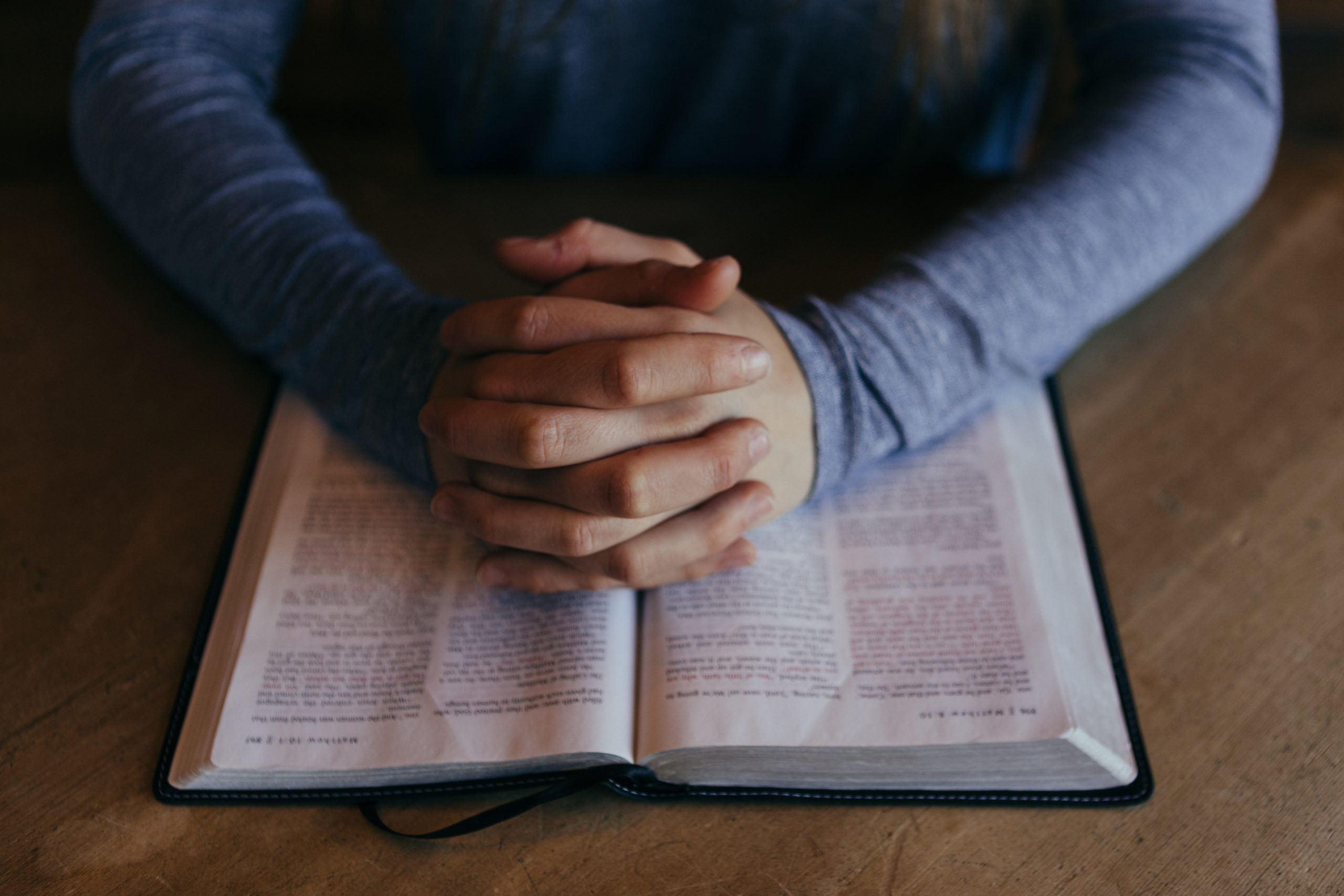 Open Bible and gathered church members
